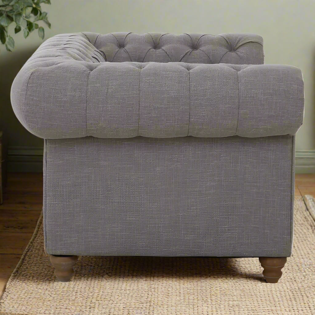 Introducing our classic chesterfield two-seat sofa, featuring a button-tufted back that exudes luxury with a touch of warmth. Timeless and elegant, it boasts gently scrolled arms that complement its smooth lines. The nail head trims add a finishing touch to the design, making this sofa a sophisticated addition to any living space.