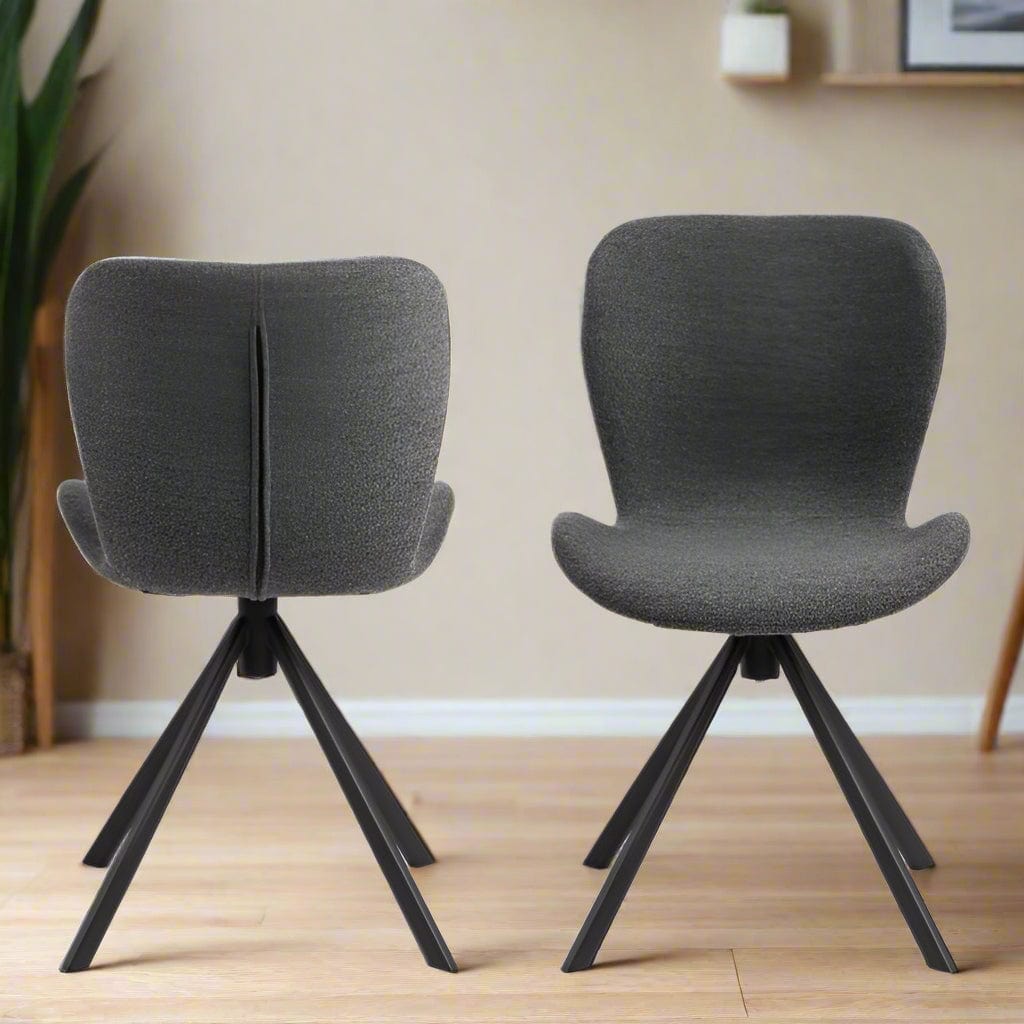Set of two dining chairs with black steel swivel base, cream bouclé fabric upholstery, and zigzag stitching, featuring a modern Danish design.