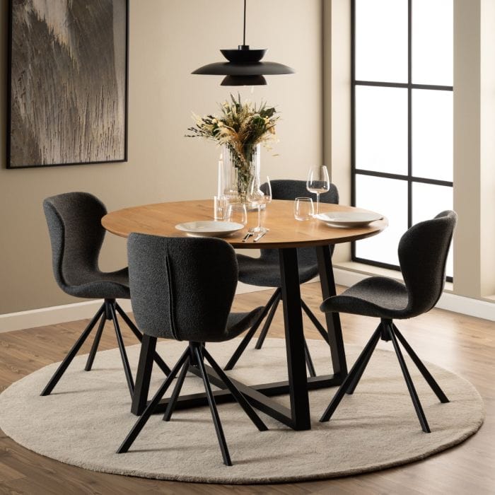 Set of two dining chairs with black steel swivel base, cream bouclé fabric upholstery, and zigzag stitching, featuring a modern Danish design.
