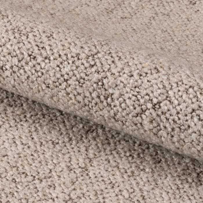 "Beige dining chair with armrests, soft bouclé fabric, tufting detail, and black powder-coated steel legs, perfect for modern dining spaces."