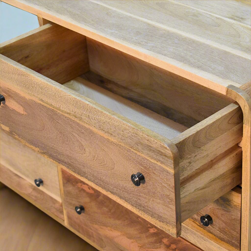 "Large Chest of Drawers made from 100% solid mango wood with oak-like finish, featuring Nordic-style legs, shiny accent knobs, and a modern curved design for contemporary home interiors."