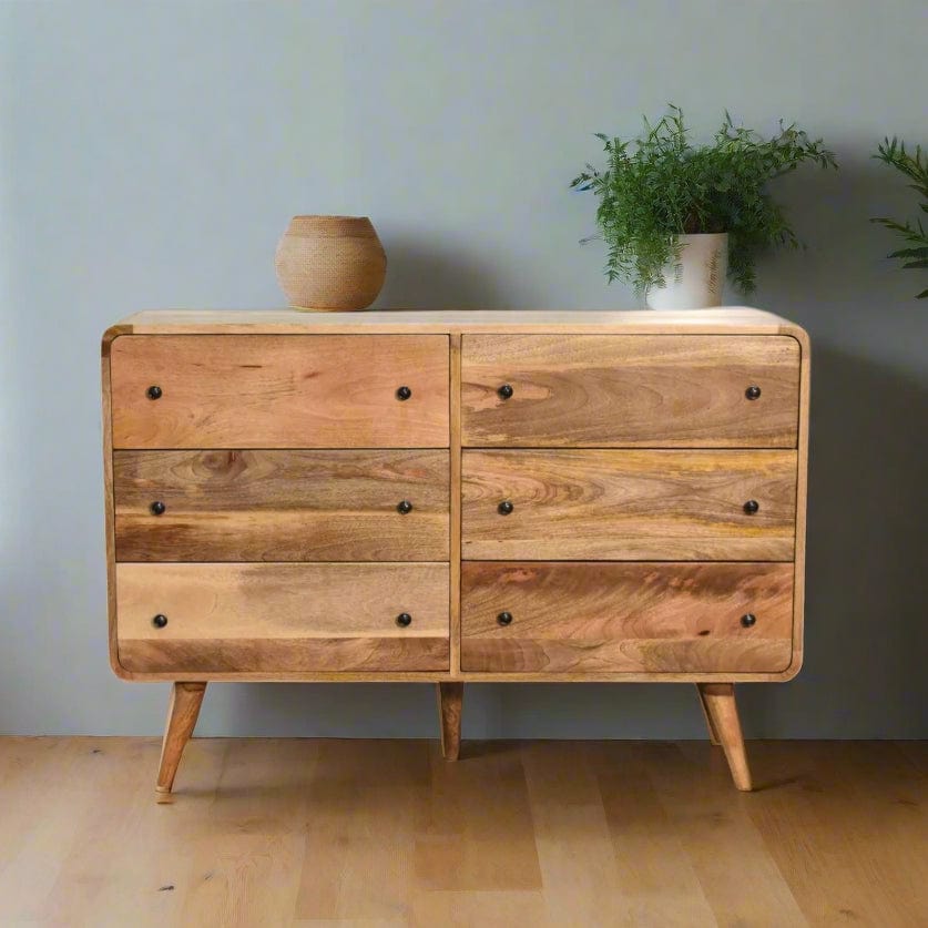 "Large Chest of Drawers made from 100% solid mango wood with oak-like finish, featuring Nordic-style legs, shiny accent knobs, and a modern curved design for contemporary home interiors."