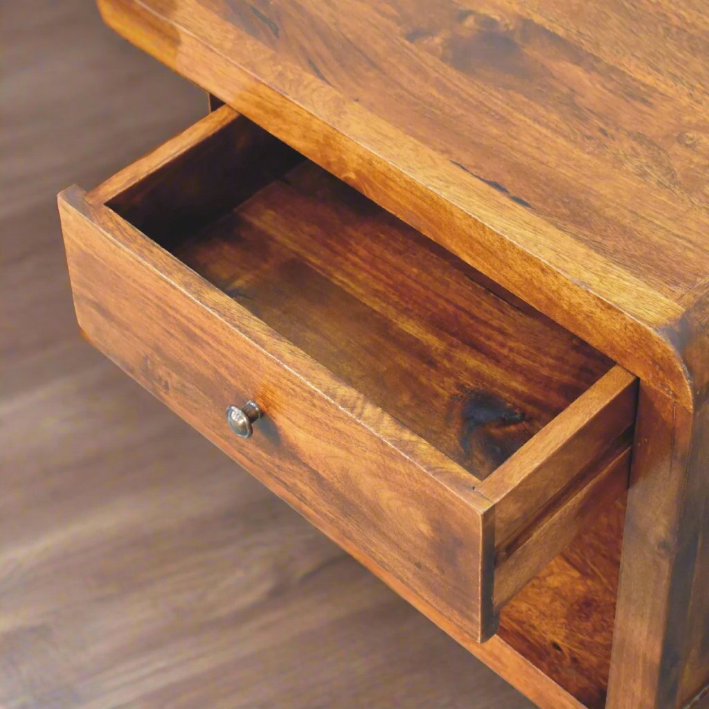 A stylish Chestnut Curved Edge Coffee Table featuring a smooth, elegant design with gently curved edges and a rich chestnut wood finish. This modern coffee table offers a spacious surface for drinks, books, and decor while adding a touch of sophistication to any living room. The curved edges enhance its sleek, contemporary look, making it a perfect fit for both modern and traditional interiors. Crafted from durable materials, this coffee table combines functionality and timeless style to elevate your home