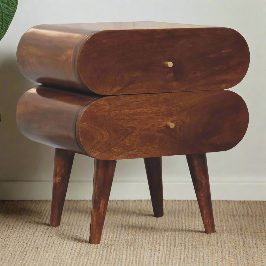 Quirky Capsule-Style Bedside Table with round drawer designs, crafted from 100% solid mango wood in a warm chestnut finish. Supported by Nordic-style legs and featuring shiny brass knobs for a modern, stylish look.