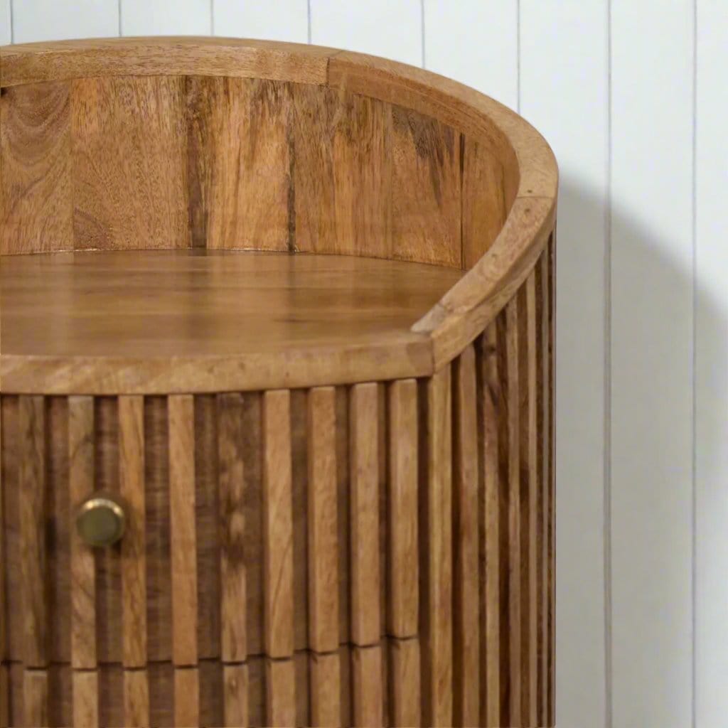 Exquisite handcarved bedside table with intricate detailing, featuring a smooth top and elegant legs, adding a touch of artisanal craftsmanship and vintage charm to any bedroom decor