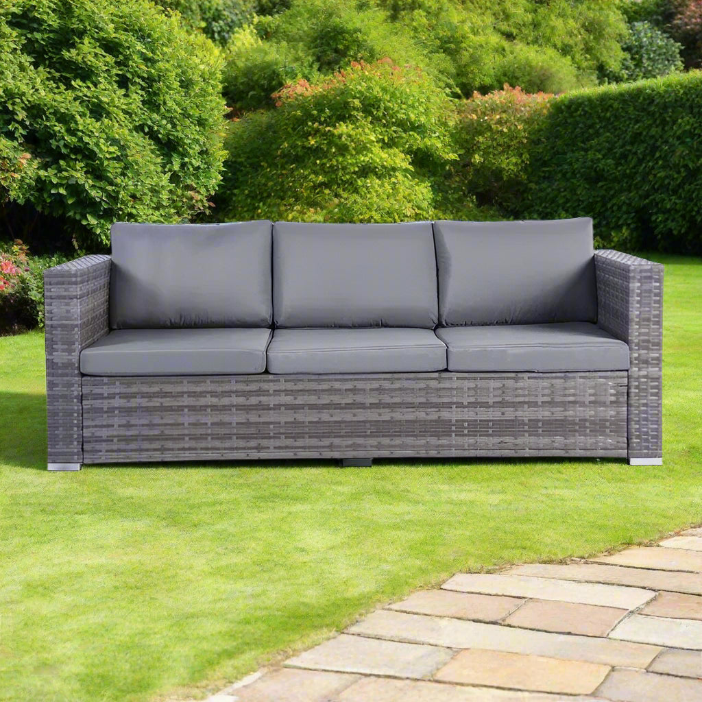 Rattan corner sofa set with contrasting colors, featuring a sofa, stool, and rectangular coffee table with a tempered glass top, made from durable PE rattan and all-weather fabric. Perfect for modern or contemporary gardens.