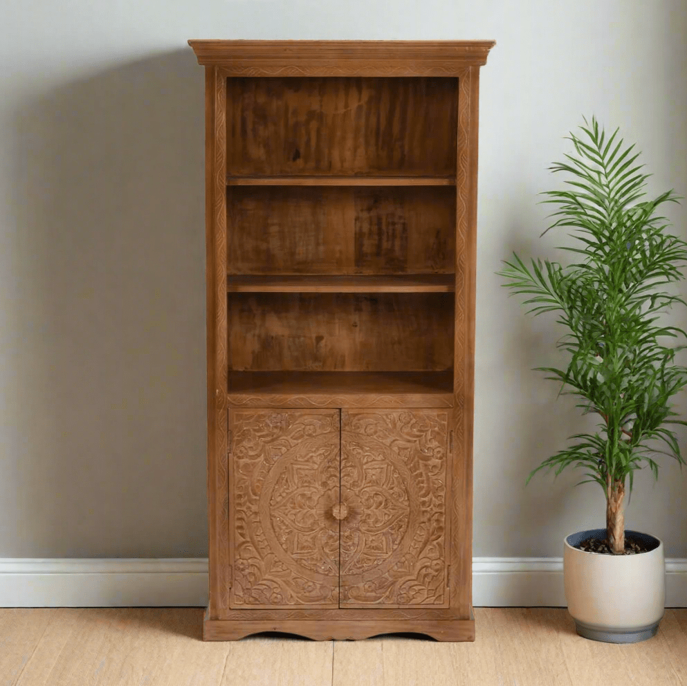 Handcrafted large bookcase made from eco-sourced mango wood, featuring hand-carved detailing, open shelving, and a two-door cupboard with a light whitewash finish