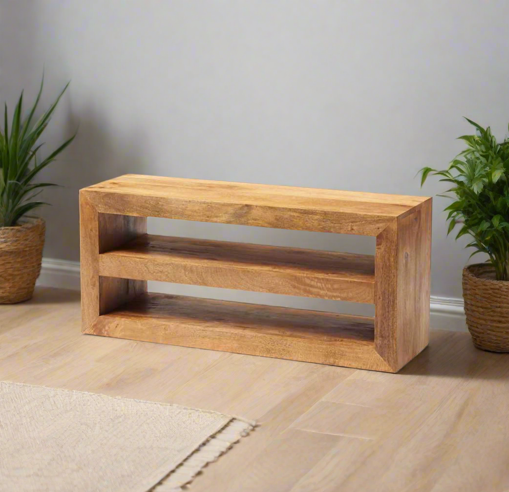 Enhance your living space with this beautifully crafted TV stand, made from 100% solid light Mango hardwood. The wood is lightly stained with a matte finish, allowing the natural beauty and warm tones of the wood to shine through. Featuring matching wooden handles, this eco-friendly piece is fully assembled and ready for use. With a focus on sustainability and craftsmanship, it brings both style and functionality to your home. Enjoy free delivery on this timeless, handcrafted TV stand.