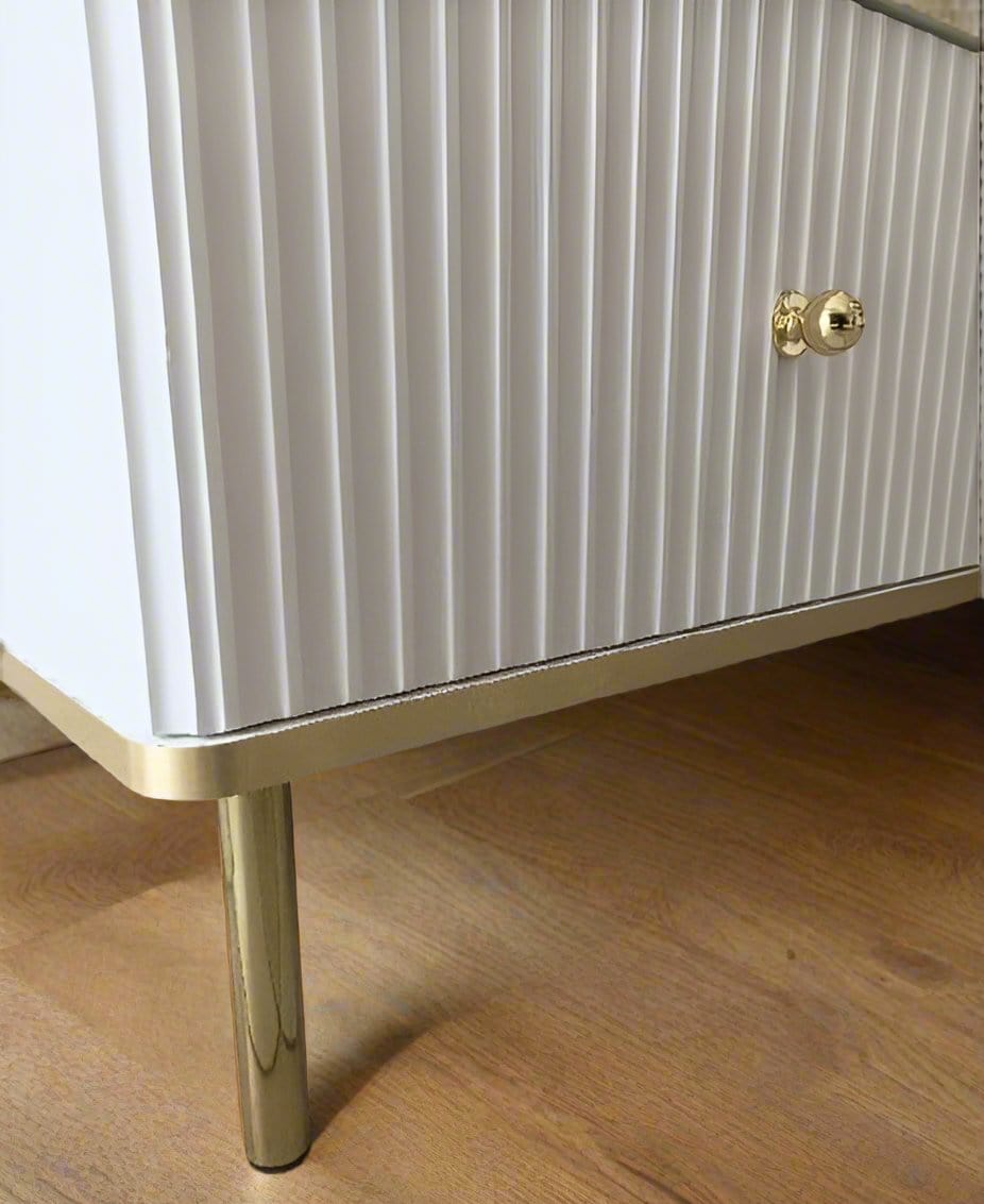 White and Gold Large Sideboard with a sleek white body, accented by elegant gold handles and edging. Features three doors with internal shelves for convenient storage. Easy to clean and maintain. Dimensions: 75cm H x 140cm W x 40cm D. Free delivery and easy assembly included.