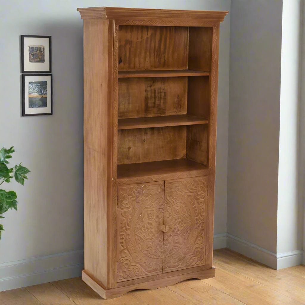 Handcrafted large bookcase made from eco-sourced mango wood, featuring hand-carved detailing, open shelving, and a two-door cupboard with a light whitewash finish