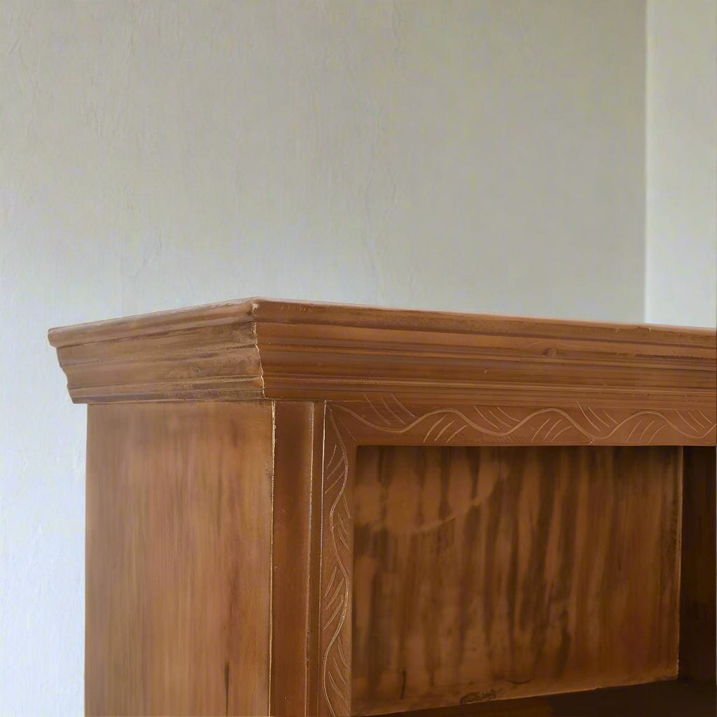 Handcrafted large bookcase made from eco-sourced mango wood, featuring hand-carved detailing, open shelving, and a two-door cupboard with a light whitewash finish