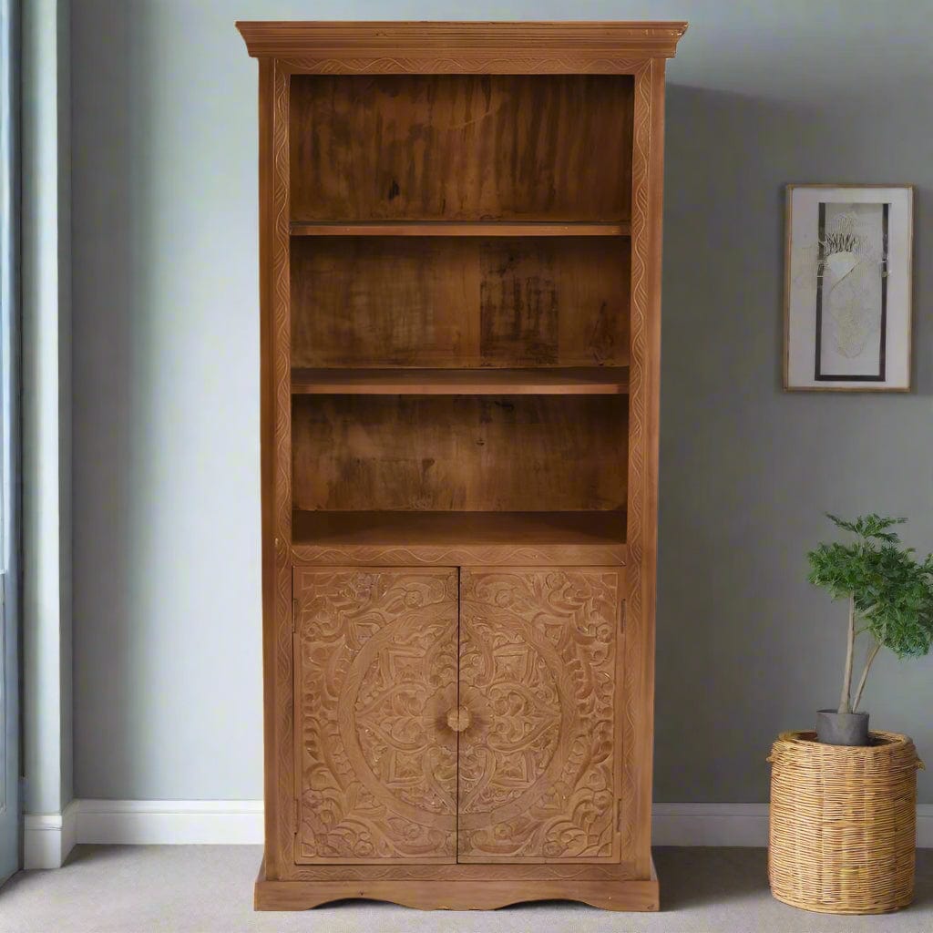 Handcrafted large bookcase made from eco-sourced mango wood, featuring hand-carved detailing, open shelving, and a two-door cupboard with a light whitewash finish