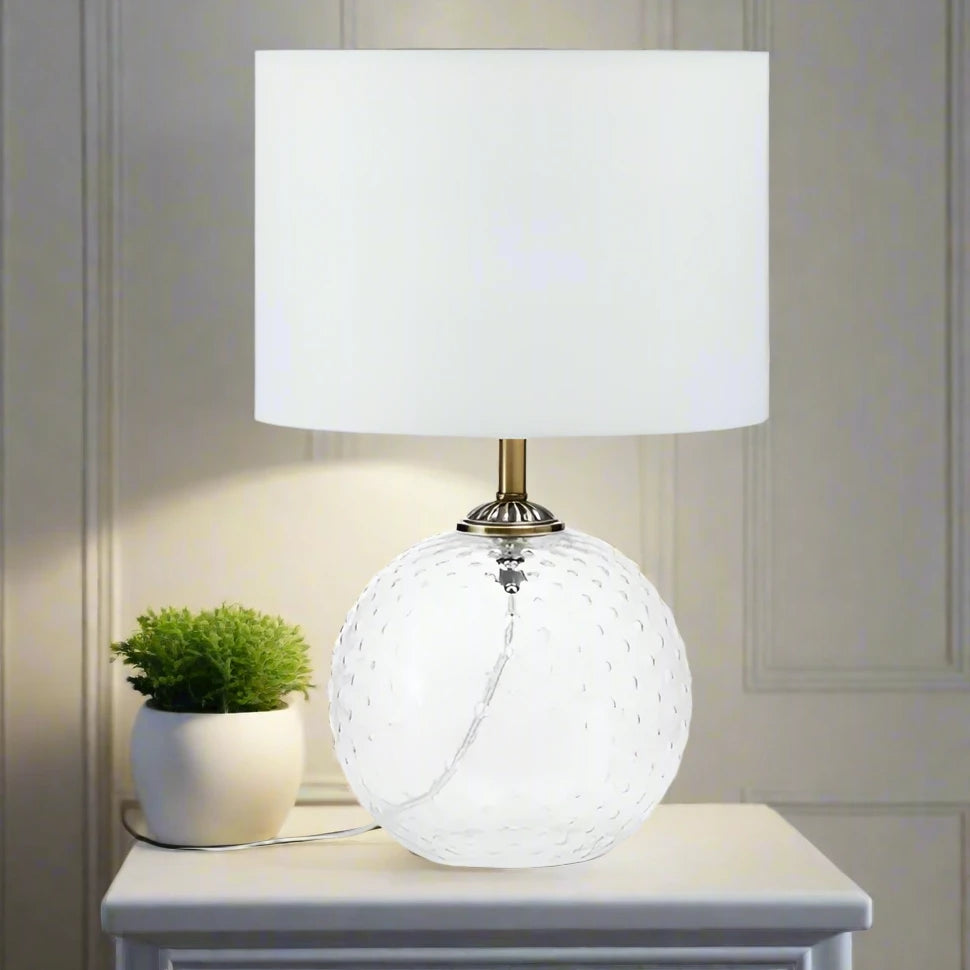 Modern glass circular white table lamp with a sleek design, featuring a round base and a minimalist shade, perfect for adding a touch of elegance and ambient lighting to any room