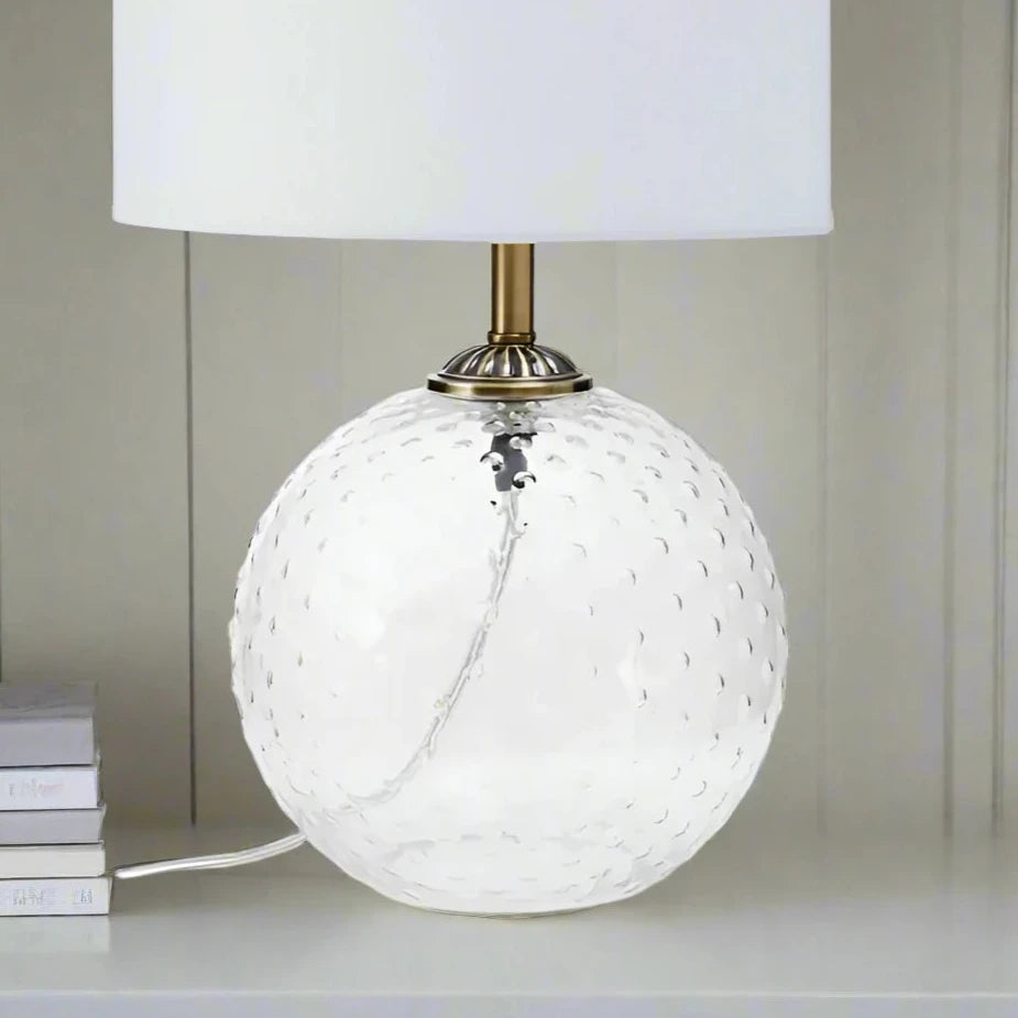 Modern glass circular white table lamp with a sleek design, featuring a round base and a minimalist shade, perfect for adding a touch of elegance and ambient lighting to any room