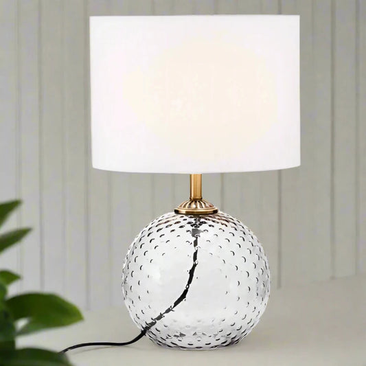 Modern glass circular grey table lamp with a sleek design, featuring a round base and a minimalist shade, perfect for adding a touch of elegance and ambient lighting to any room