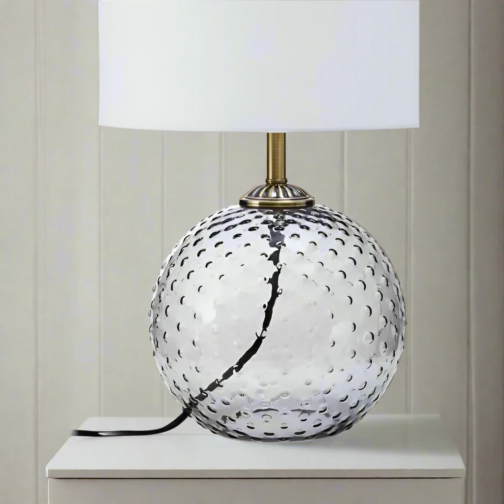Modern glass circular grey table lamp with a sleek design, featuring a round base and a minimalist shade, perfect for adding a touch of elegance and ambient lighting to any room