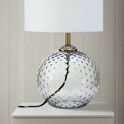 Modern glass circular grey table lamp with a sleek design, featuring a round base and a minimalist shade, perfect for adding a touch of elegance and ambient lighting to any room