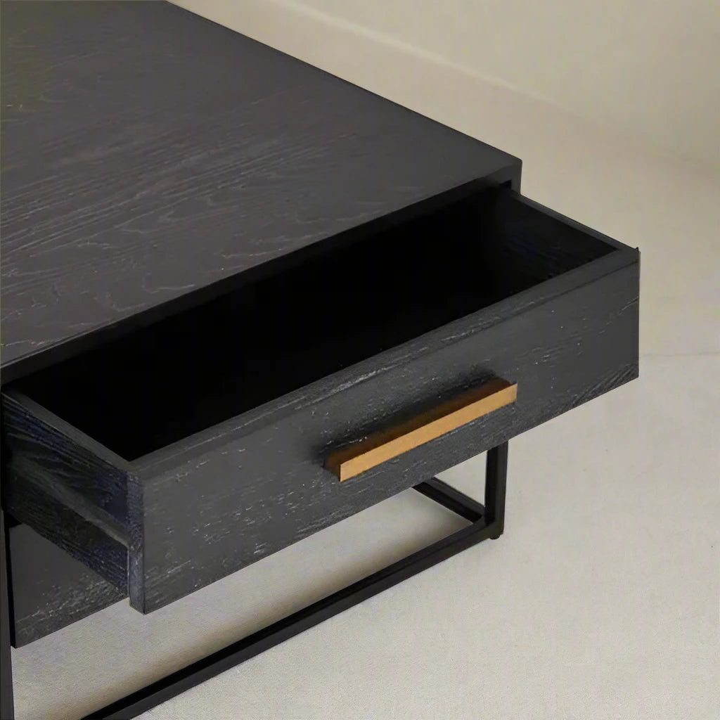 Black Wood 4 Drawer Coffee Table with sleek black wood veneer finish, gold finish handles, and angular black metal base. Ideal for modern living rooms, offering both style and storage. Dimensions: H40 x L70 x W120.