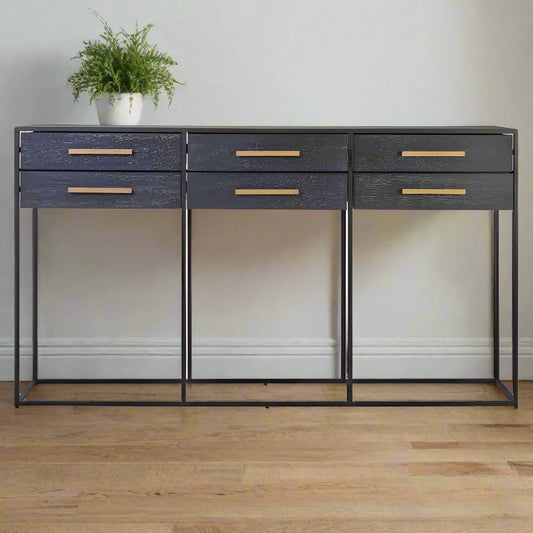 Six Drawer Console Table with smooth black wood veneer finish, gold finish handles on each sliding drawer, and angular black metal base. Stylish and functional storage solution for modern interiors.