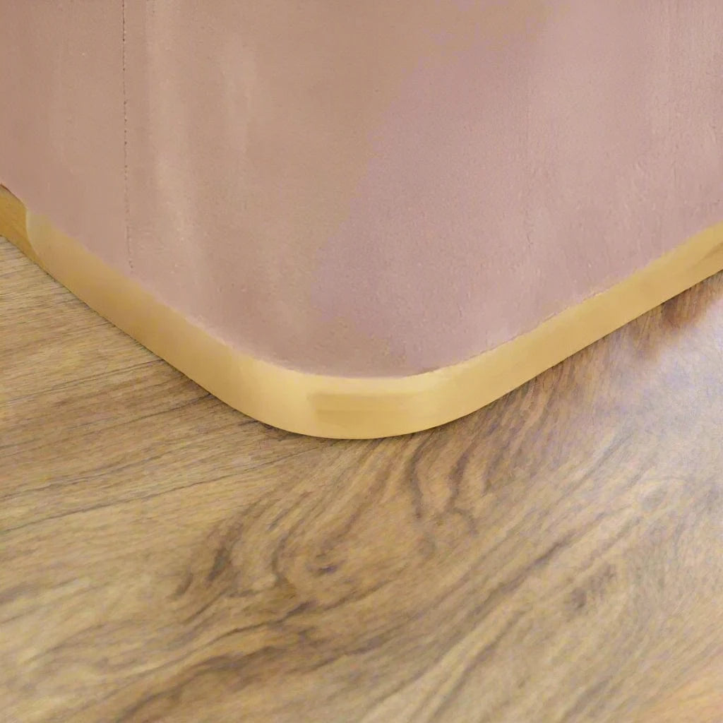 pink velvet stool with square design and matte gold finish base, offering a contemporary luxe style.