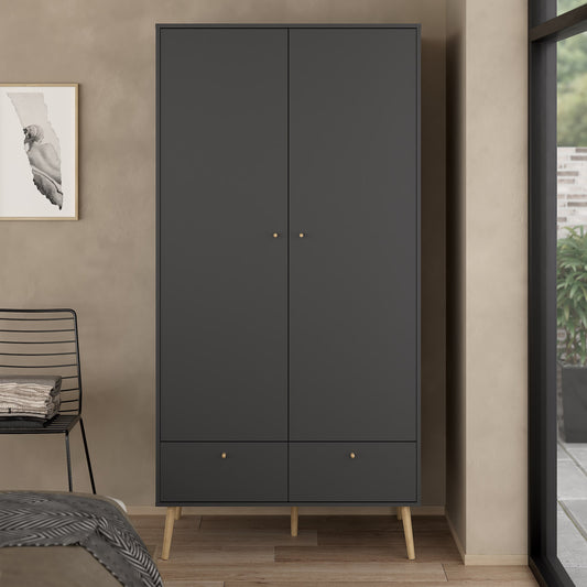 A modern black oak wardrobe with two drawers, featuring a sleek design and ample storage space. Crafted from durable black oak wood, this wardrobe combines functionality and elegance, offering a stylish solution for organizing clothing and accessories. The two drawers provide additional storage for smaller items, while the wardrobe section offers hanging space. Perfect for bedrooms or closets, this black oak wardrobe enhances your home decor with a sophisticated, contemporary look.