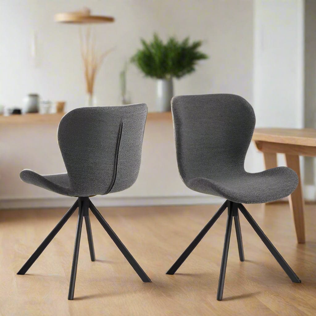 Set of two dining chairs with black steel swivel base, cream bouclé fabric upholstery, and zigzag stitching, featuring a modern Danish design.