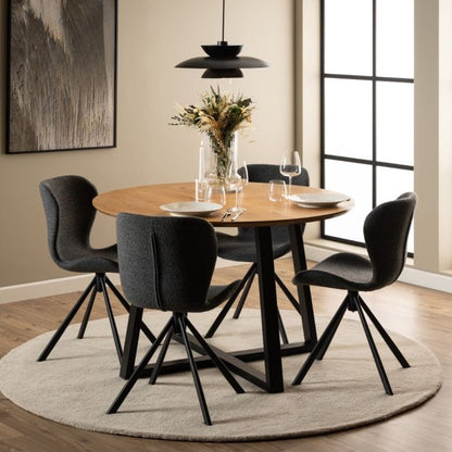 Set of two dining chairs with black steel swivel base, cream bouclé fabric upholstery, and zigzag stitching, featuring a modern Danish design.
