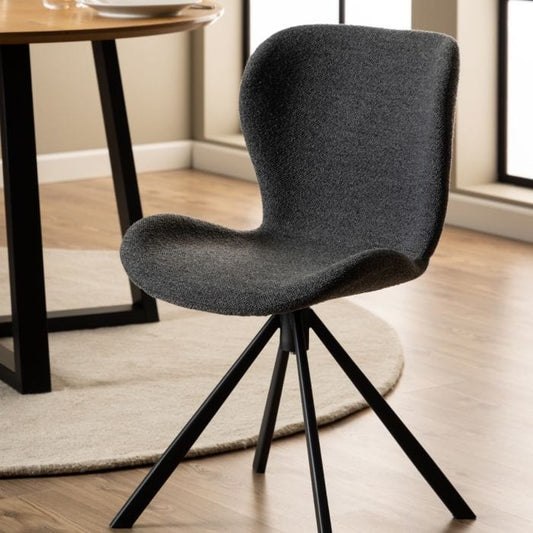 Set of two dining chairs with black steel swivel base, cream bouclé fabric upholstery, and zigzag stitching, featuring a modern Danish design.