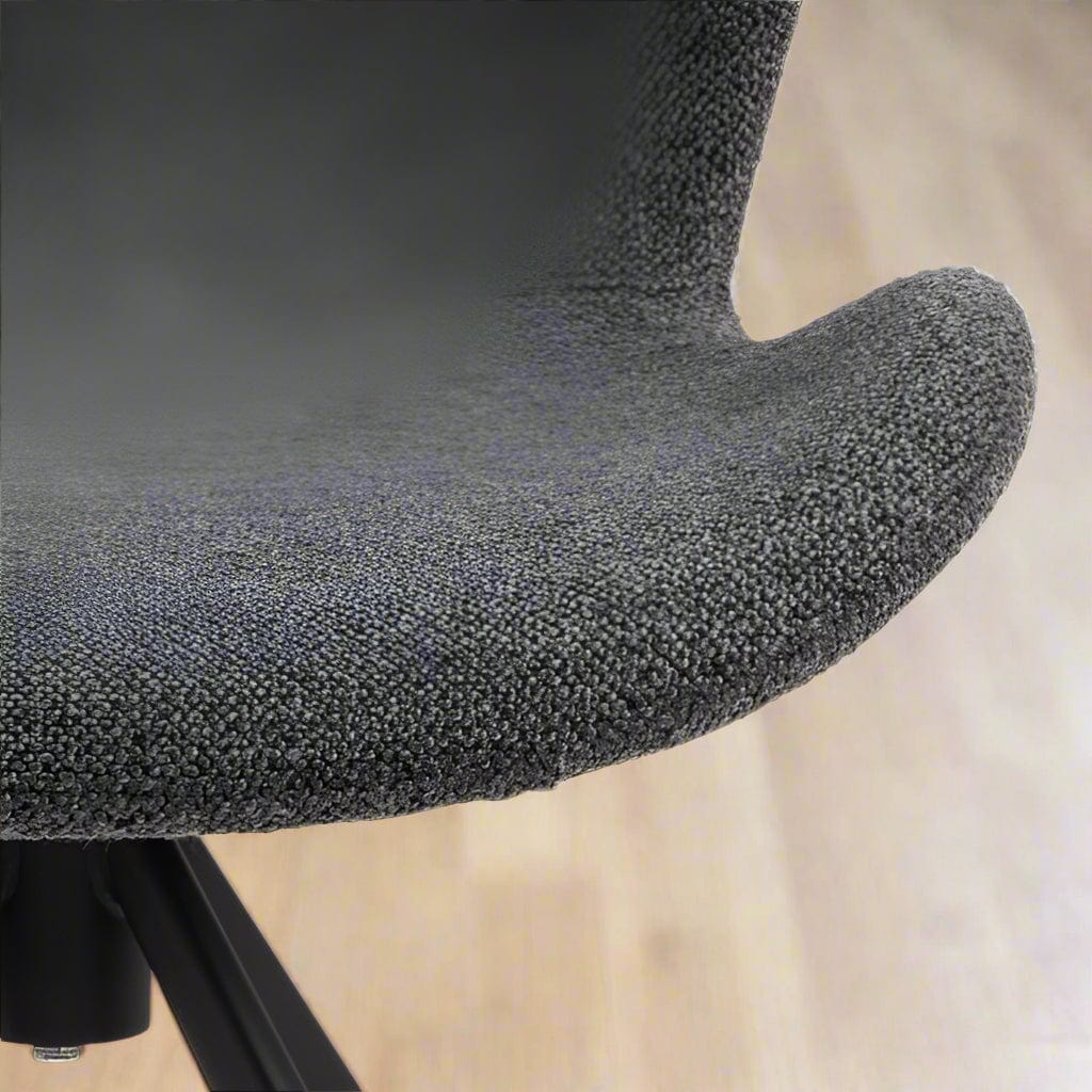 Set of two dining chairs with black steel swivel base, cream bouclé fabric upholstery, and zigzag stitching, featuring a modern Danish design.