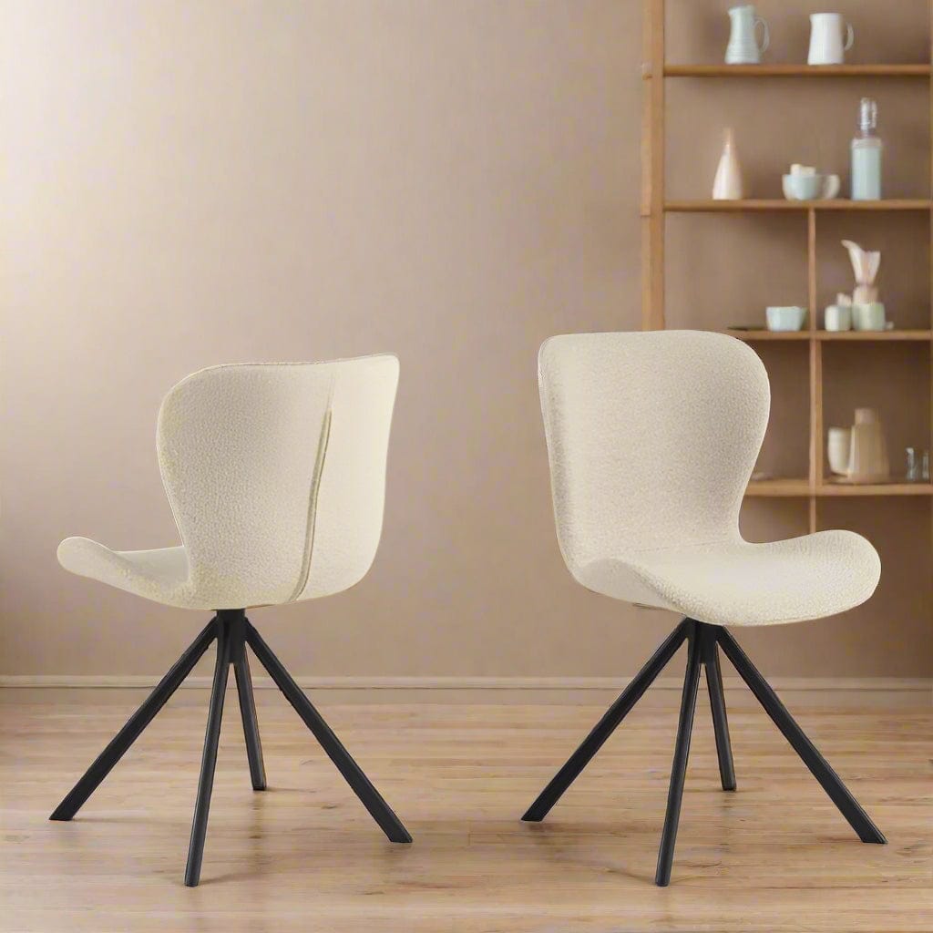 Set of two dining chairs with black steel swivel base, cream bouclé fabric upholstery, and zigzag stitching, featuring a modern Danish design.