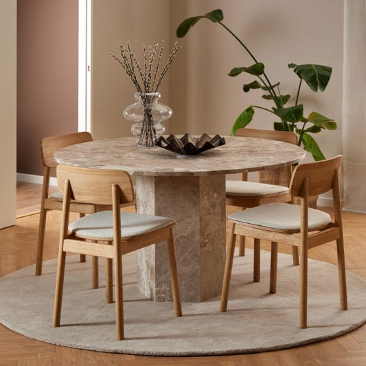 Stunning marble top dining table with a round tabletop featuring natural stone variations and a hexagonal pillar base. A sophisticated blend of contemporary design and timeless elegance, perfect for modern dining rooms.