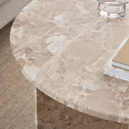 Timeless coffee table with a round latte brown marble top and unique natural stone variations. Features a striking V-shaped base, blending elegance with practicality for modern and classic interiors.