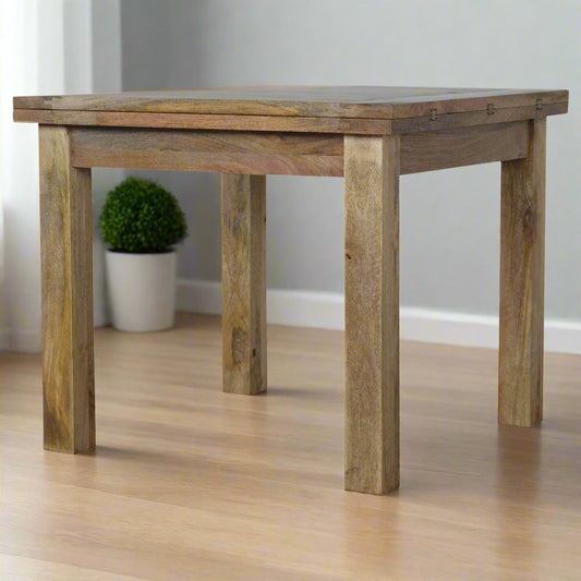 Rustic wooden table with a natural finish, placed on a polished hardwood floor in a modern kitchen setting, featuring sturdy square legs and a simple, functional design