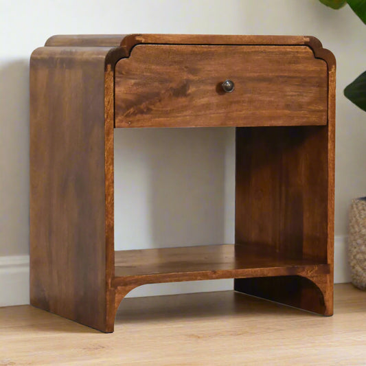 "Newton Bedside table made from solid mango wood with chestnut finish, featuring a spacious drawer, an additional shelf, and a shiny brass knob for added elegance."