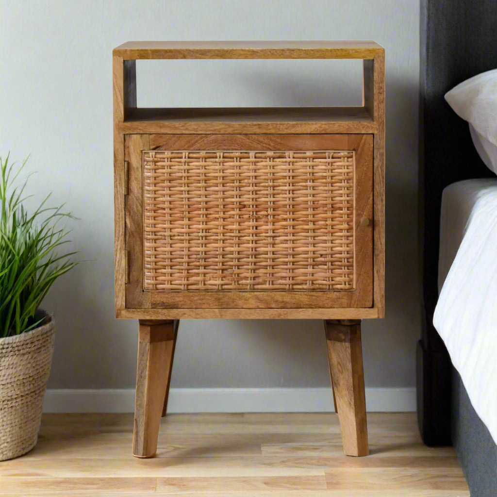 Oak knit effect bedside table made from mango wood, with rattan door front and Nordic-style legs, offering stylish storage.