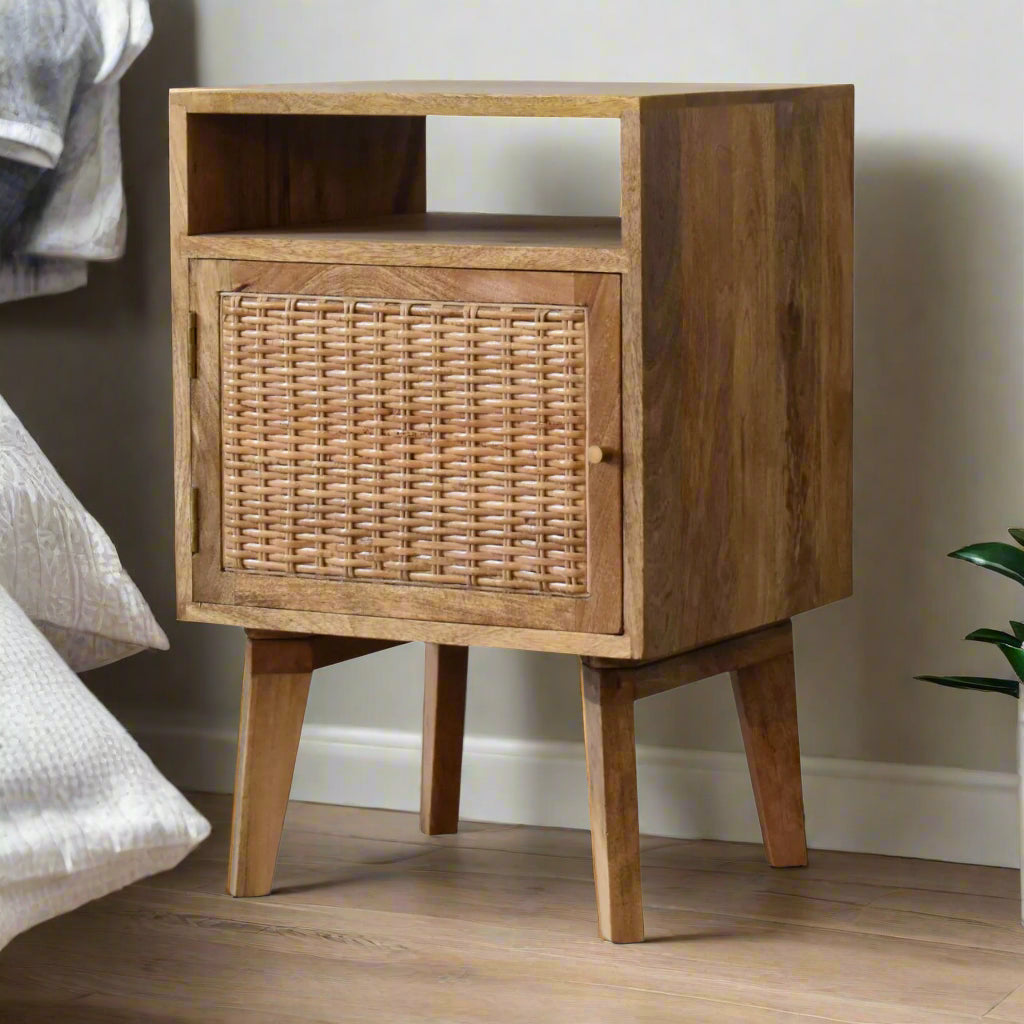 Oak knit effect bedside table made from mango wood, with rattan door front and Nordic-style legs, offering stylish storage.