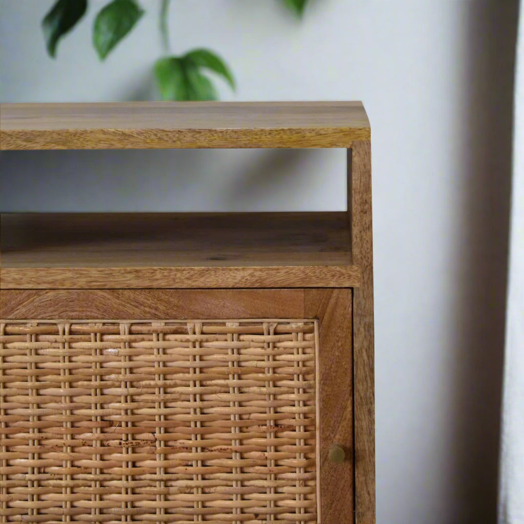 Oak knit effect bedside table made from mango wood, with rattan door front and Nordic-style legs, offering stylish storage.