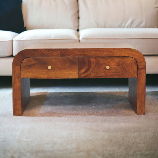 
A Chestnut Rounded Edge Coffee Table featuring a smooth, rounded design and a rich chestnut wood finish. This elegant coffee table offers a spacious surface for drinks, books, and decor, adding both style and functionality to your living room. The rounded edges provide a soft, modern aesthetic, making it a perfect fit for contemporary or traditional interiors. Crafted from high-quality wood, this coffee table enhances your home decor with its timeless appeal and versatile design.