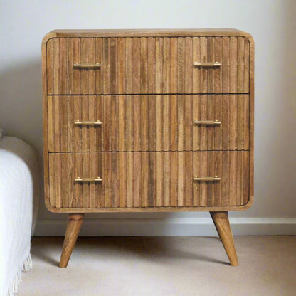 T-bar Ridged Chest made from solid mango wood with an oak-ish finish, featuring a ridged pattern, T-bar handles, and Nordic-style legs for a modern, stylish look.