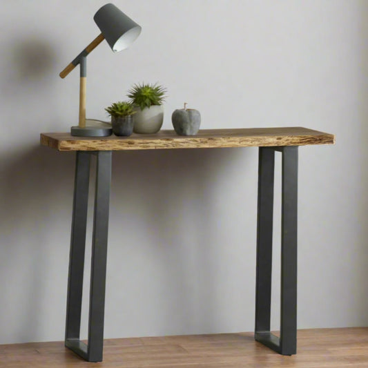 
Elevate your space with the Solid Acacia Wood Console Table, featuring a live edge top that showcases the natural beauty of eco-friendly wood. Fully assembled for convenience, this stylish table measures 100x35x78 cm (LxDxH) and adds both function and elegance to any room. Please note that color variations may occur due to the unique properties of the wood. Enhance your decor with this sustainably crafted, one-of-a-kind console table, now available with free delivery for a seamless experience.