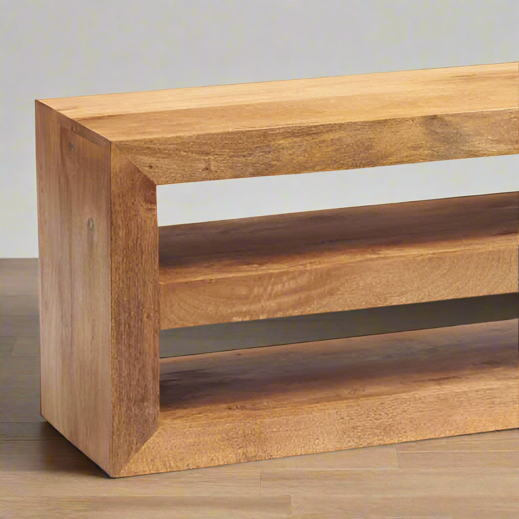 Enhance your living space with this beautifully crafted TV stand, made from 100% solid light Mango hardwood. The wood is lightly stained with a matte finish, allowing the natural beauty and warm tones of the wood to shine through. Featuring matching wooden handles, this eco-friendly piece is fully assembled and ready for use. With a focus on sustainability and craftsmanship, it brings both style and functionality to your home. Enjoy free delivery on this timeless, handcrafted TV stand.