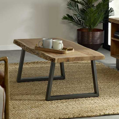 Coffee table with live edge solid acacia wood top, eco-friendly, supported by sturdy sled-shaped metal legs for a natural, rustic look.