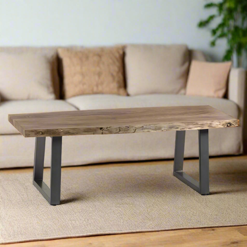Coffee table with live edge solid acacia wood top, eco-friendly, supported by sturdy sled-shaped metal legs for a natural, rustic look.