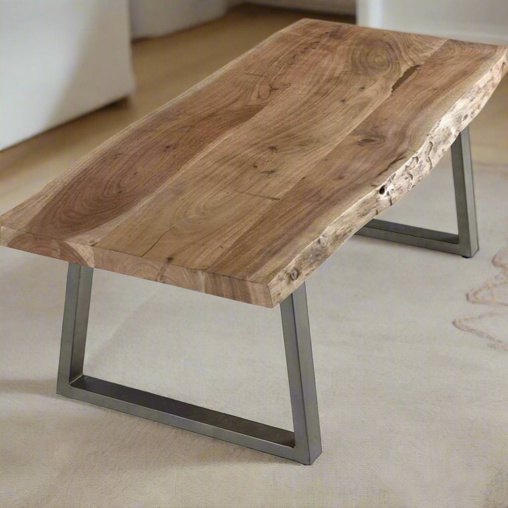 Coffee table with live edge solid acacia wood top, eco-friendly, supported by sturdy sled-shaped metal legs for a natural, rustic look.