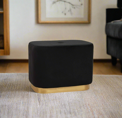 Black velvet stool with square design and matte gold finish base, offering a contemporary luxe style.